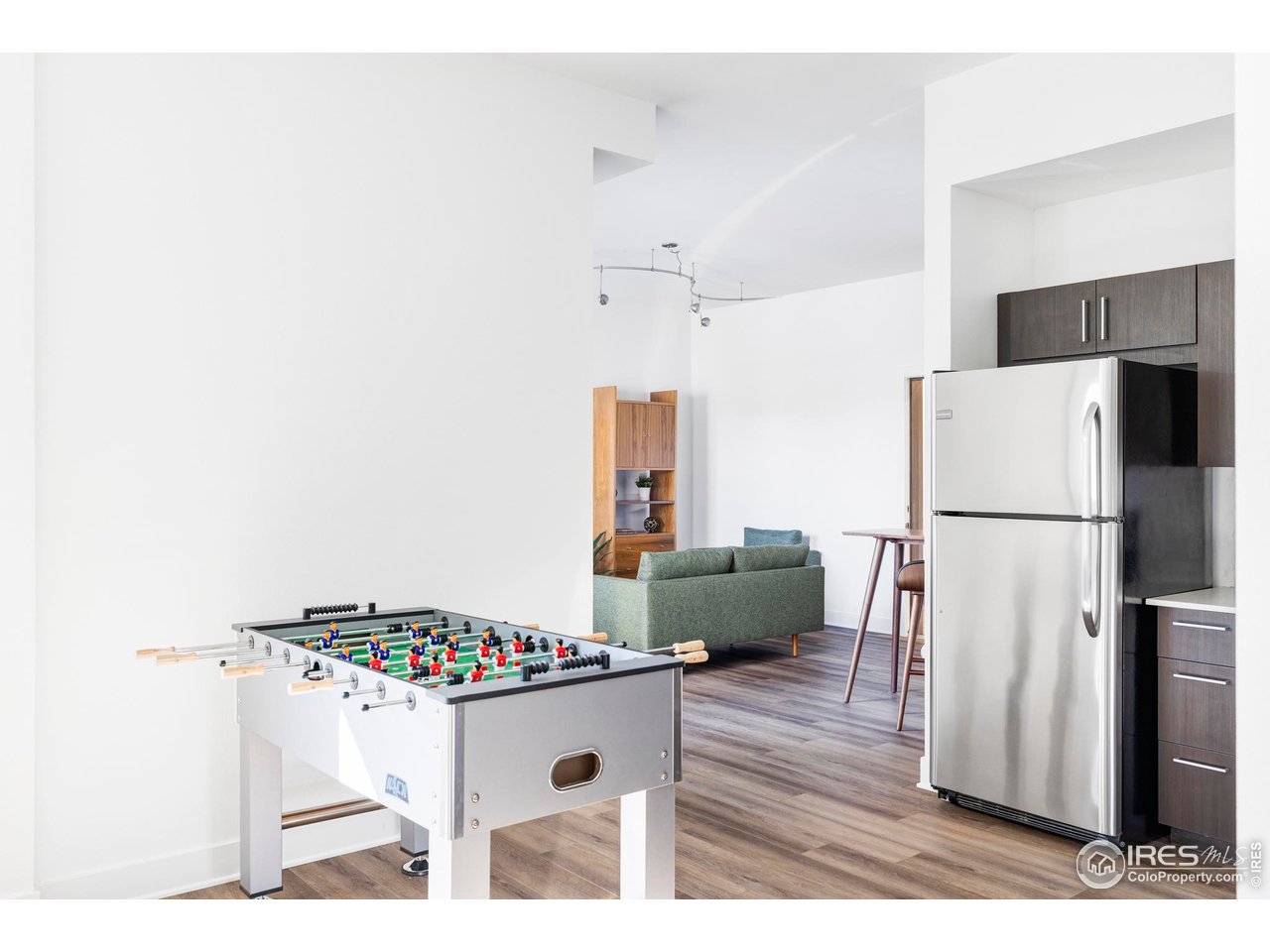 1707 Walnut Street, Unit 208 Boulder, CO 80302 - Photo 11 of 30 a kitchen with a refrigerator and a wooden floor