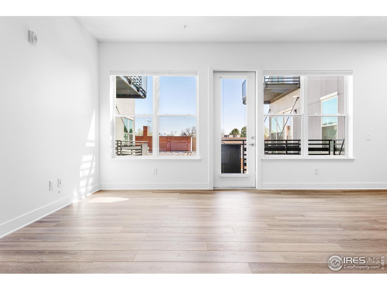 1707 Walnut Street, Unit 208 Boulder, CO 80302 - Photo 2 of 30 a view of an empty room with window and wooden floor