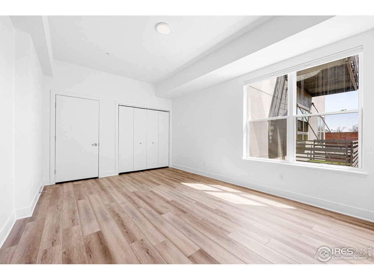1707 Walnut Street, Unit 208 Boulder, CO 80302 - Photo 8 of 30 a view of an empty room with wooden floor and a window