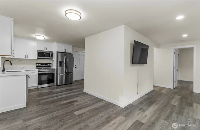 a kitchen with a refrigerator and a stove top oven