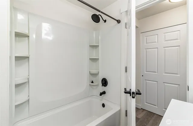 a bathroom with a bathtub and a shower