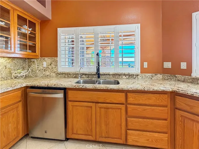 a kitchen with granite countertop cabinets and window