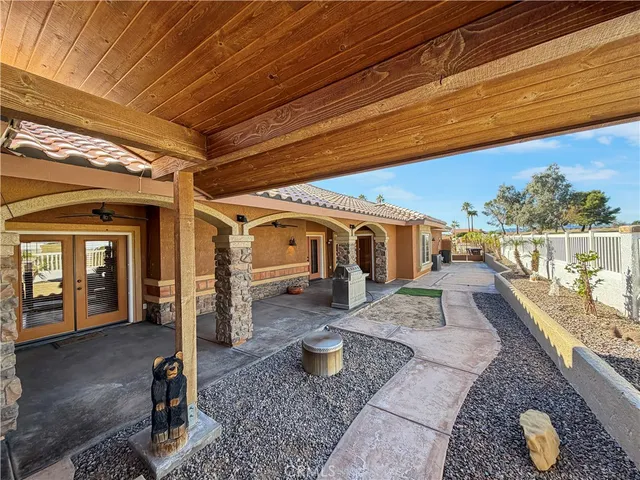 a view of a porch with furniture and a yard