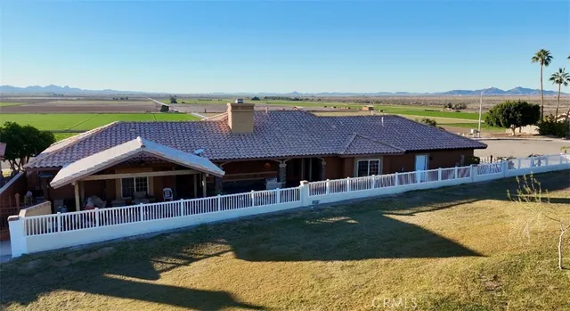a view of a house with swimming pool and sitting area
