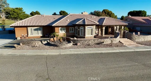 a view of house with yard outdoor seating and covered with flat screen tv