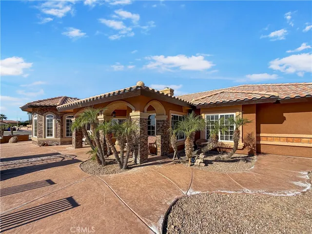 a big house with palm trees in the background