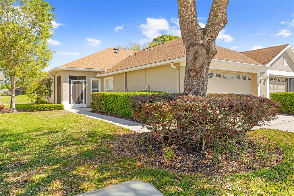 14471 Sterling Run Spring Hill, FL 34609 - Photo 1 of 1 a front view of a house with a yard and garage