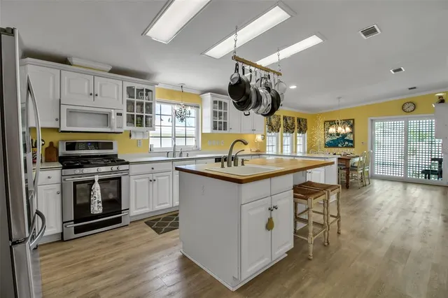 a kitchen with a sink cabinets and wooden floor