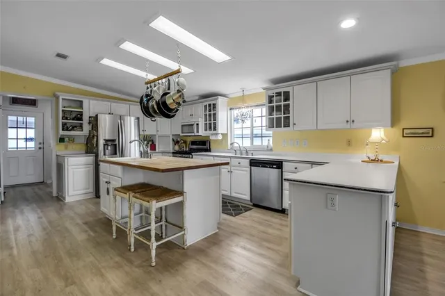 a room with painting on the wall and a mirror