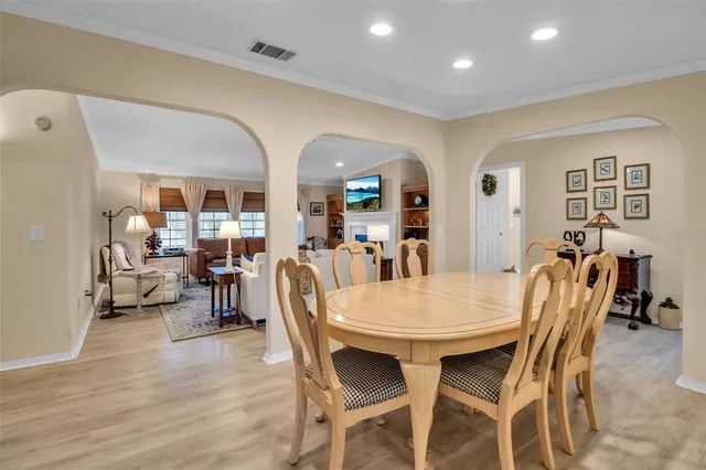 a spacious bedroom with a bed and a chandelier