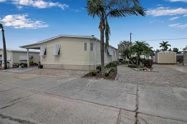 a view of a house with backyard and porch