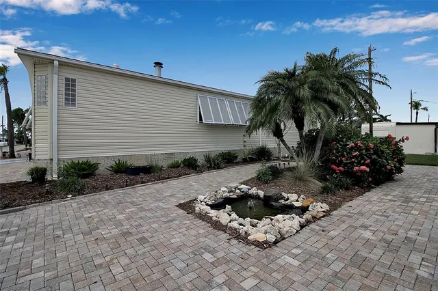 a backyard of a house with barbeque oven and covered with trees