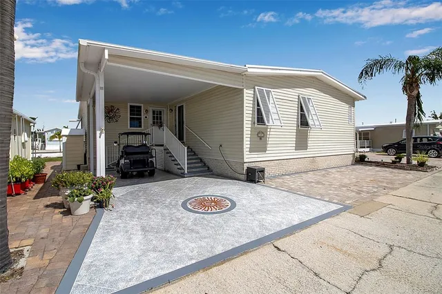 a kitchen with stainless steel appliances granite countertop a sink a stove and a wooden floors