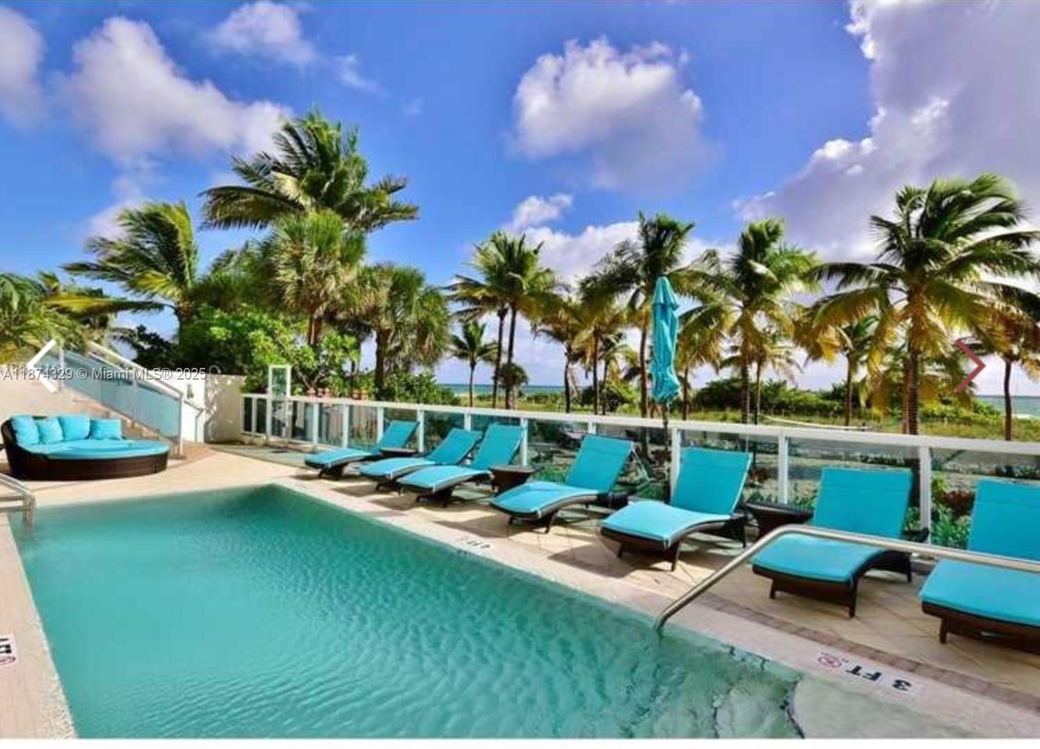 9201 Collins Avenue, Unit 921 Surfside, FL 33154 - Photo 15 of 15 a view of a swimming pool with a patio and a garden