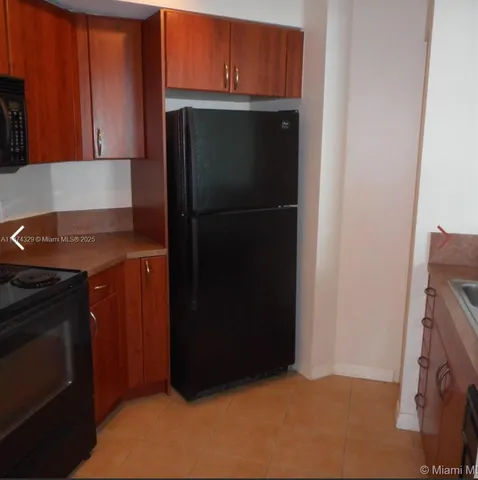 a kitchen with a refrigerator and cabinets