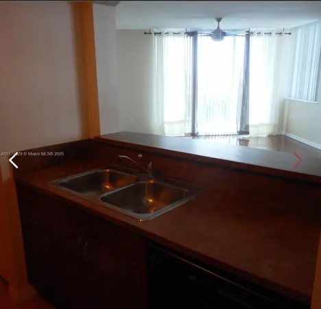 a kitchen with a sink and a window