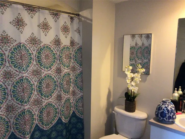a bathroom with a sink toilet and mirror
