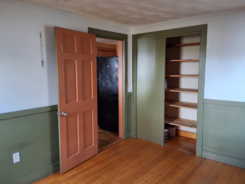 35 Pleasant Street Ware, MA 01082 - Photo 11 of 30 a view of a bedroom with wooden floor and closet