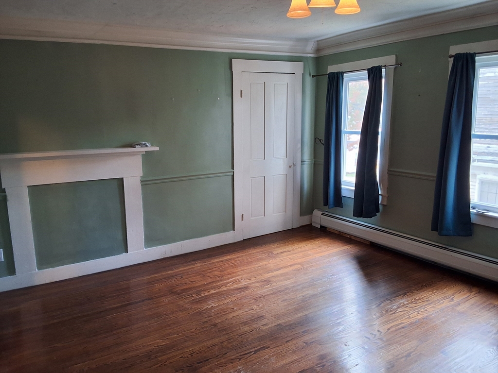 35 Pleasant Street Ware, MA 01082 - Photo 26 of 30 an empty room with wooden floor and windows