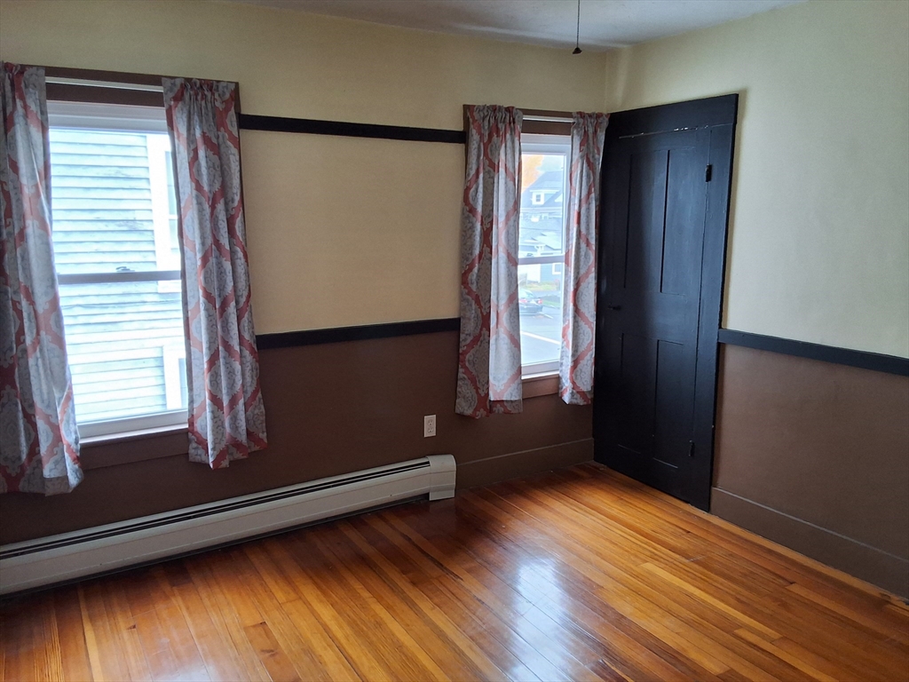 35 Pleasant Street Ware, MA 01082 - Photo 27 of 30 a view of an empty room with wooden floor and a window