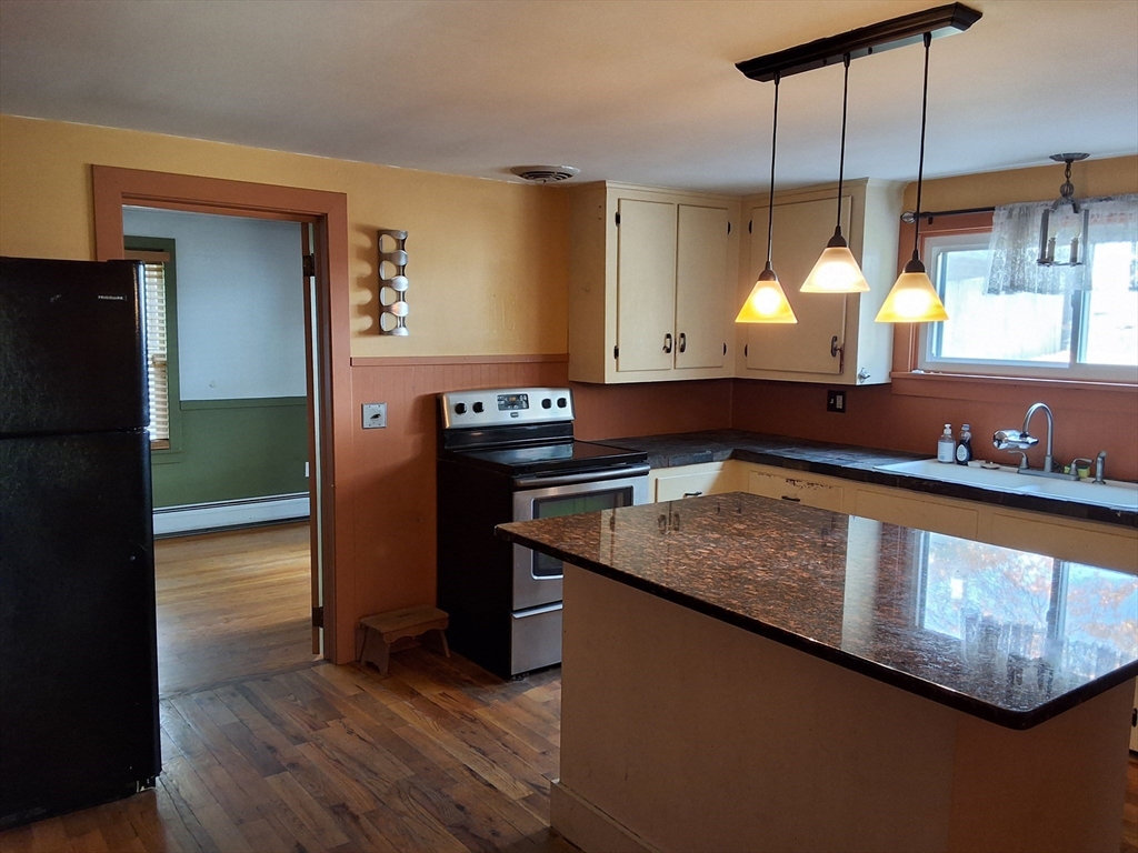 35 Pleasant Street Ware, MA 01082 - Photo 7 of 30 a kitchen with stainless steel appliances granite countertop a sink a stove and a wooden floor
