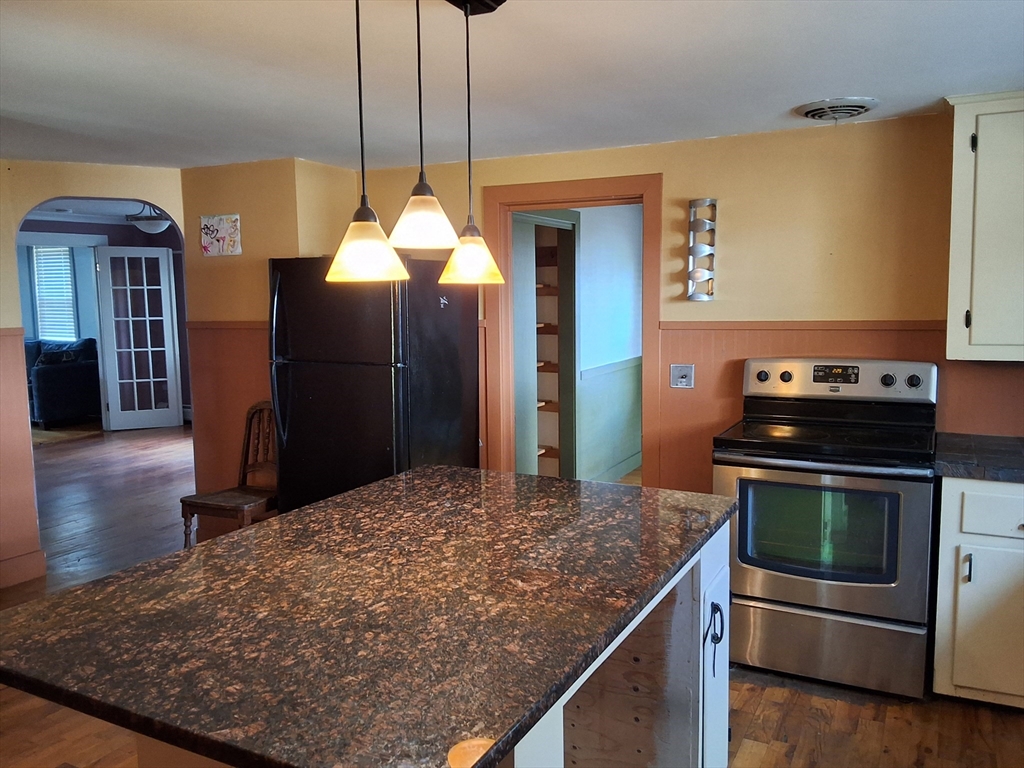 35 Pleasant Street Ware, MA 01082 - Photo 9 of 30 a kitchen with kitchen island a counter space a sink appliances and cabinets