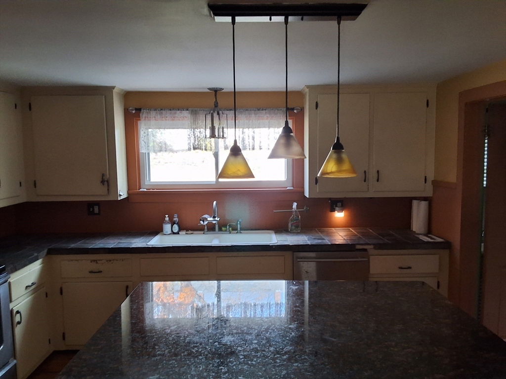 35 Pleasant Street Ware, MA 01082 - Photo 10 of 30 a kitchen with a sink a stove and cabinets