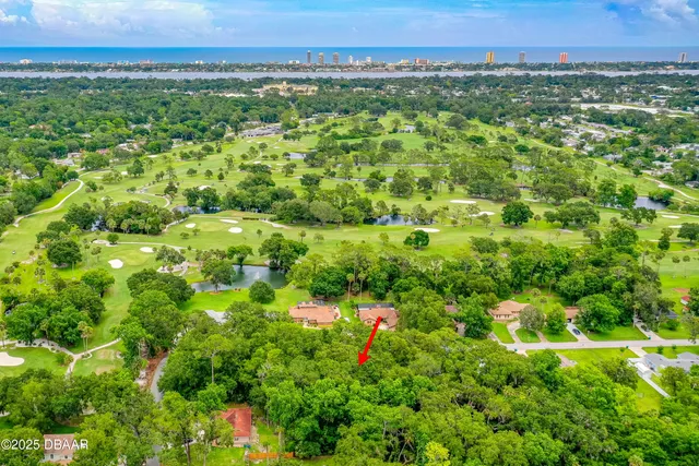 a view of a green field with lots of bushes