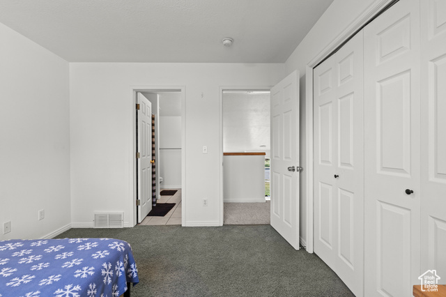 1099 Three Point Avenue Logan, UT 84321 - Photo 11 of 27 Carpeted bedroom featuring a closet and tile patterned floors