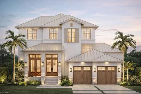 a front view of a house with a yard and potted plants