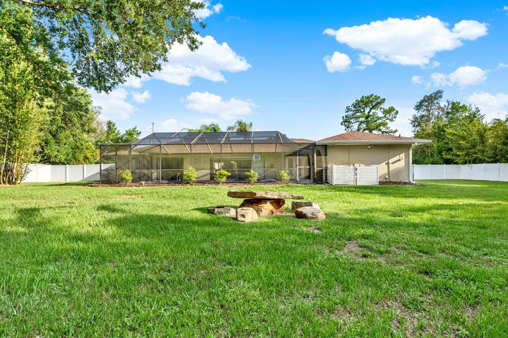 7487 River Country Drive Weeki Wachee, FL 34607 - Photo 48 of 53 a view of a house with a backyard porch and sitting area
