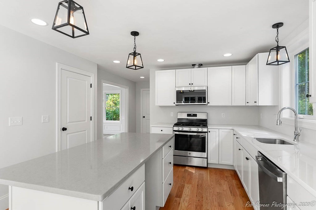 23 Ipswich Road Topsfield, MA 01983 - Photo 18 of 41 a kitchen with granite countertop a sink stainless steel appliances and white cabinets