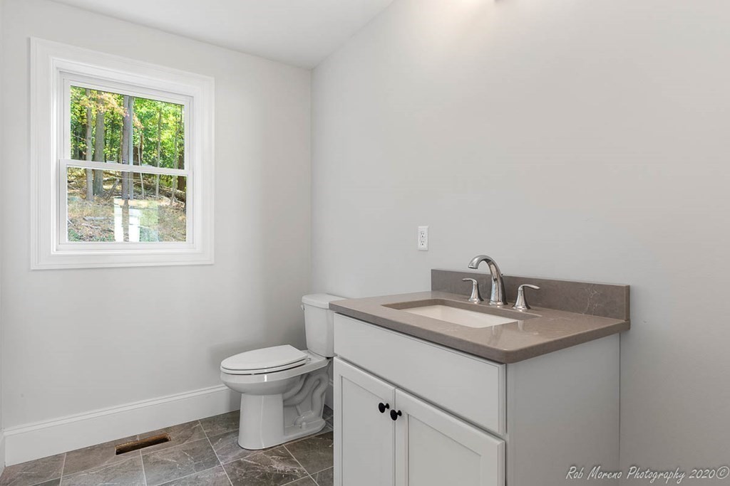 23 Ipswich Road Topsfield, MA 01983 - Photo 21 of 41 a bathroom with a granite countertop sink a toilet and a window
