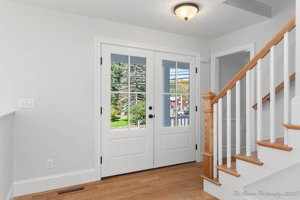23 Ipswich Road Topsfield, MA 01983 - Photo 7 of 41 an entryway with wooden floor and stairs