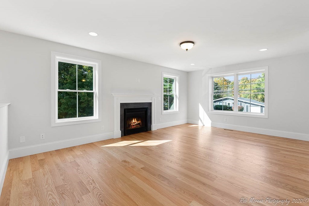 23 Ipswich Road Topsfield, MA 01983 - Photo 9 of 41 an empty room with windows and fireplace