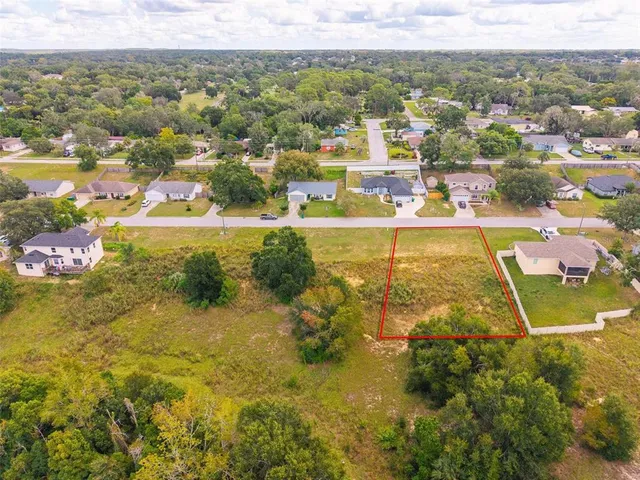 an aerial view of residential building with green space