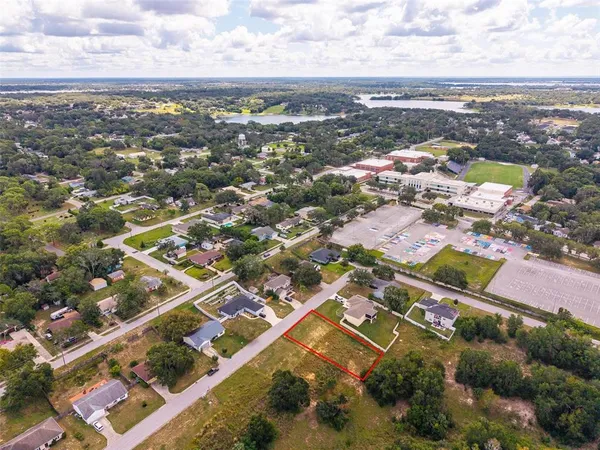 an aerial view of residential building with green space