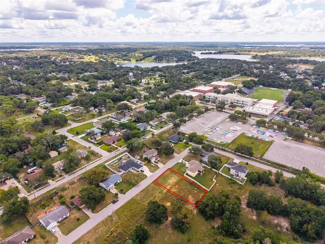 an aerial view of residential building with green space