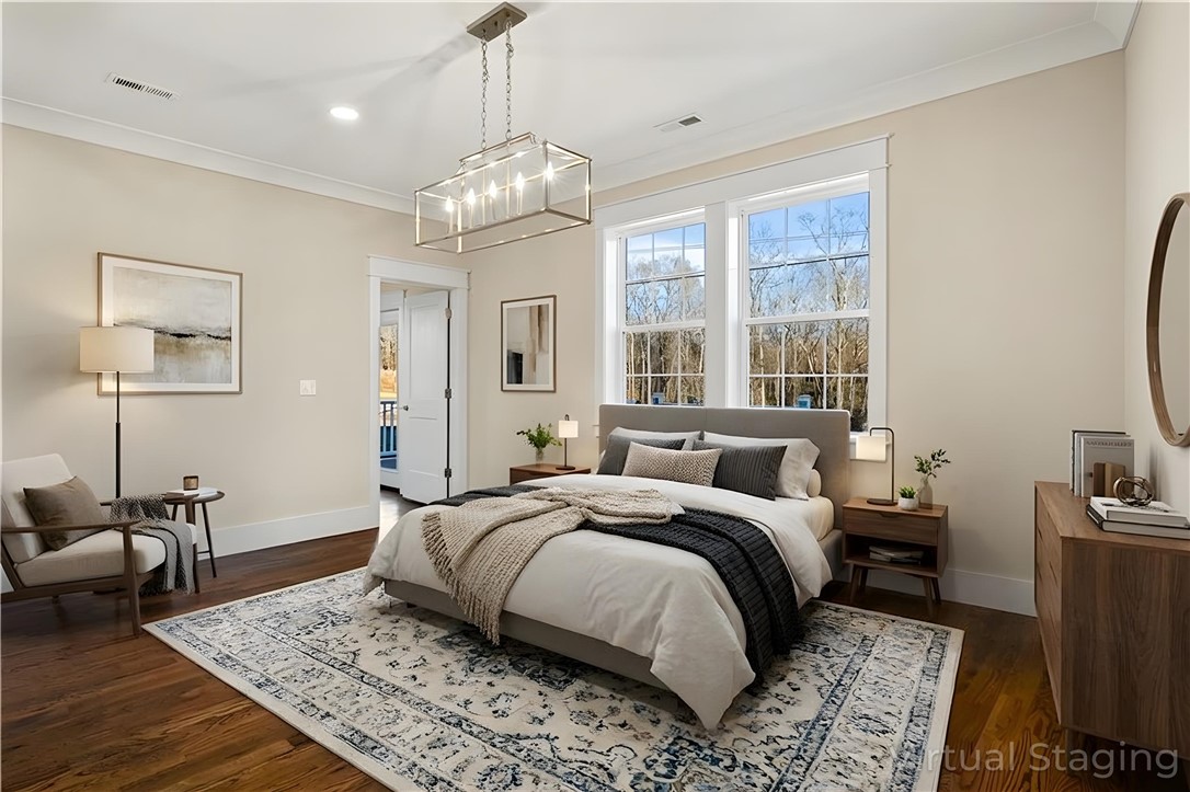 303 Regency Circle Anderson, SC 29625 - Photo 24 of 50 Bright and airy, this bedroom features rich hardwood flooring and large windows with serene outdoor views.