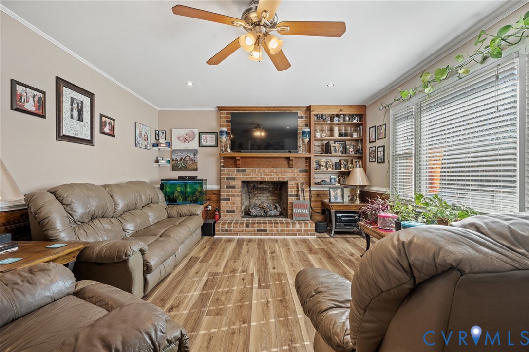 7749 Drexelbrook Road Chesterfield, VA 23832 - Photo 8 of 24 a living room with furniture a flat screen tv and a fireplace