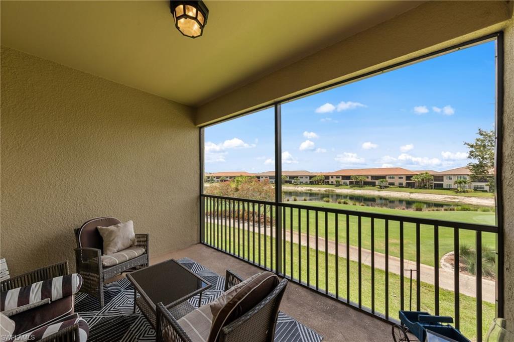 9366 Pocida Court, Unit 202 Naples, FL 34119 - Photo 23 of 44 a view of a balcony with chair and table