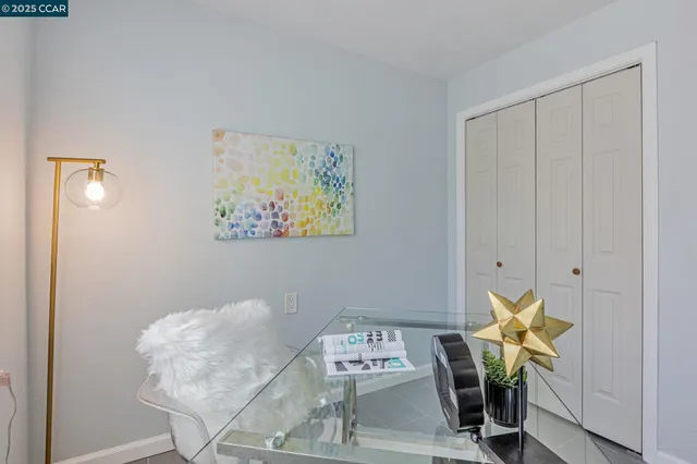 a bed sitting in a bedroom next to a window