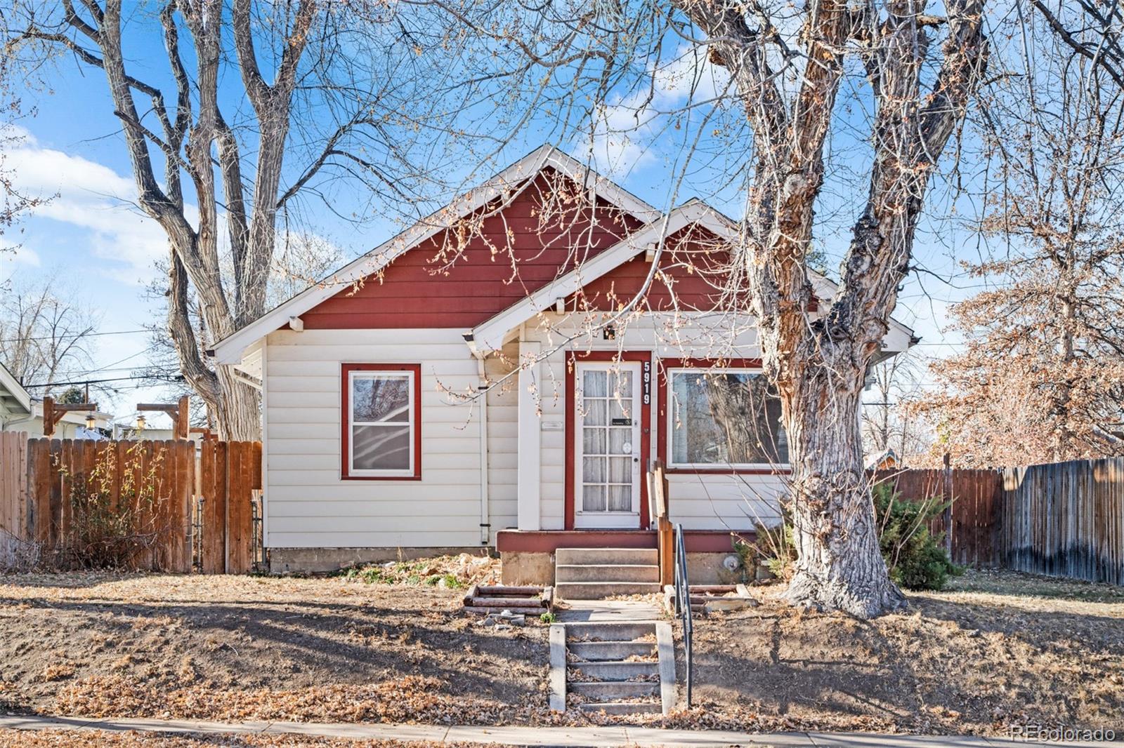 5919 South Bemis Street Littleton, CO 80120 - Photo 1 of 43 a front view of a house with a yard