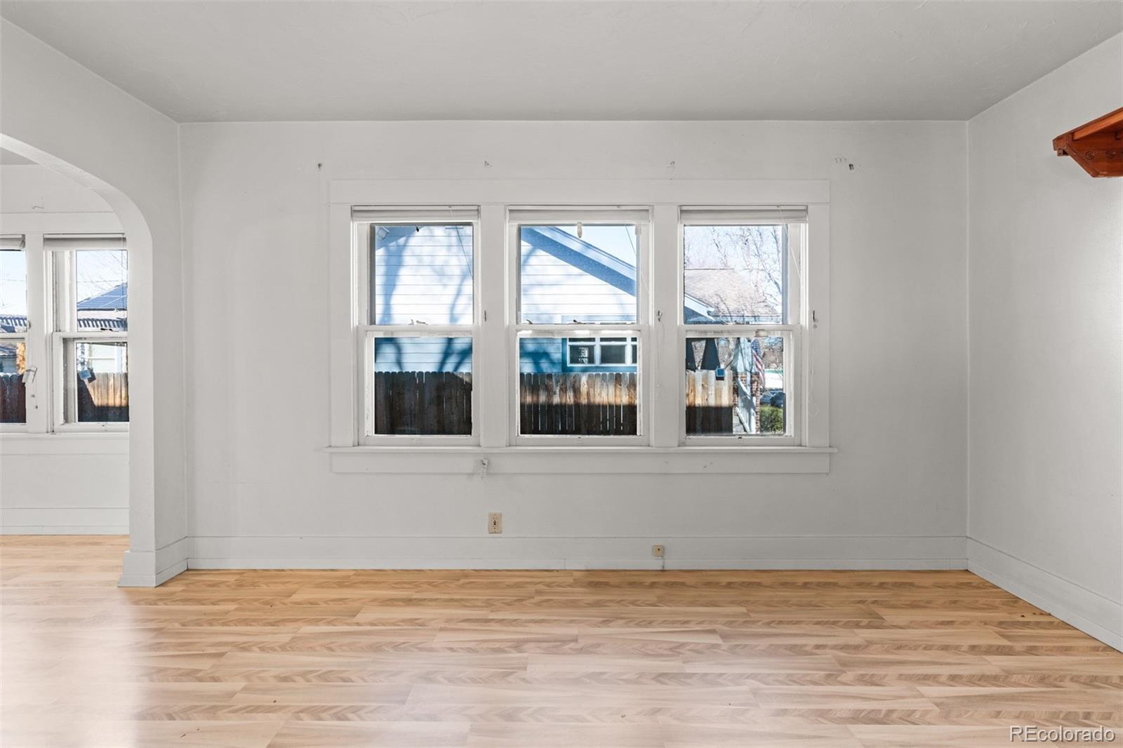5919 South Bemis Street Littleton, CO 80120 - Photo 11 of 43 a view of an empty room with wooden floor and a window