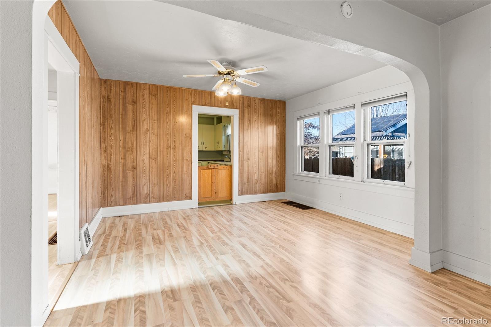 5919 South Bemis Street Littleton, CO 80120 - Photo 13 of 43 a view of an empty room with window and wooden floor