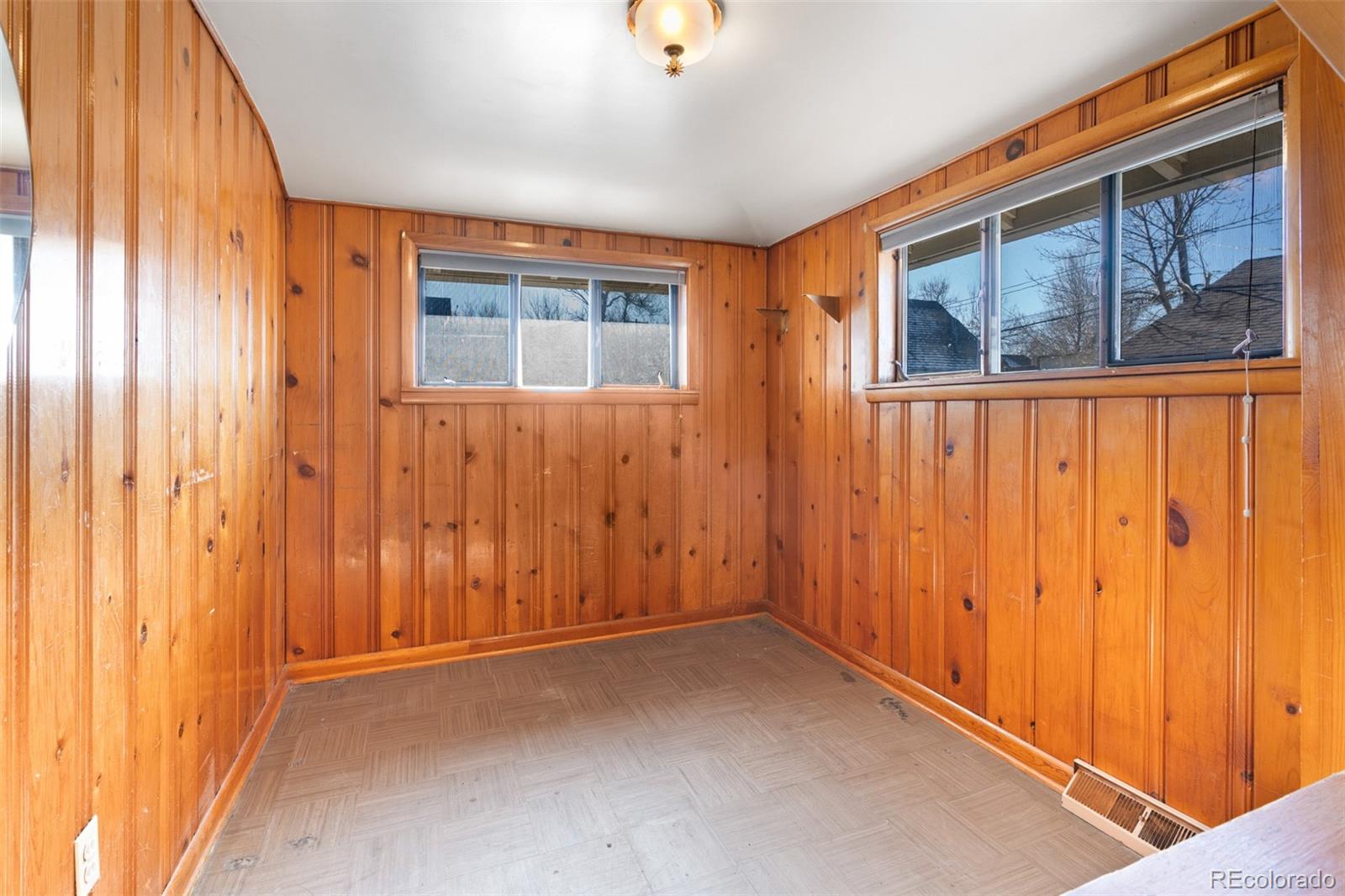 5919 South Bemis Street Littleton, CO 80120 - Photo 23 of 43 a view of an empty room with wooden floor and windows