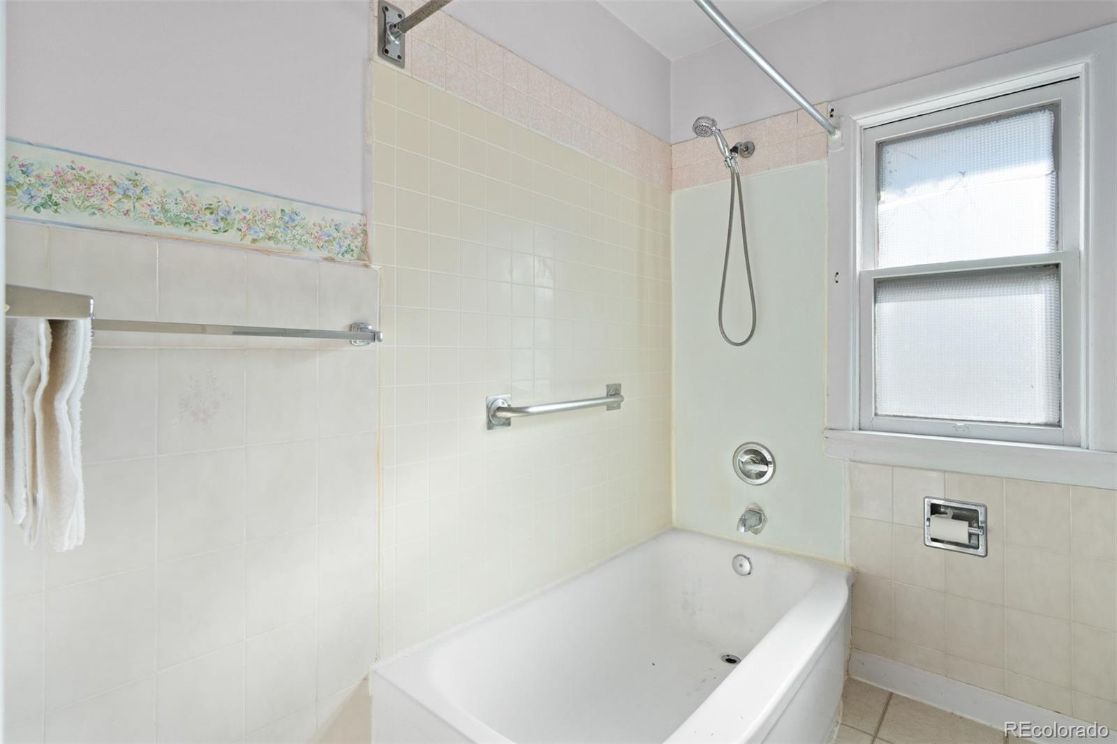 5919 South Bemis Street Littleton, CO 80120 - Photo 29 of 43 a bathroom with a white bath tub and a shower