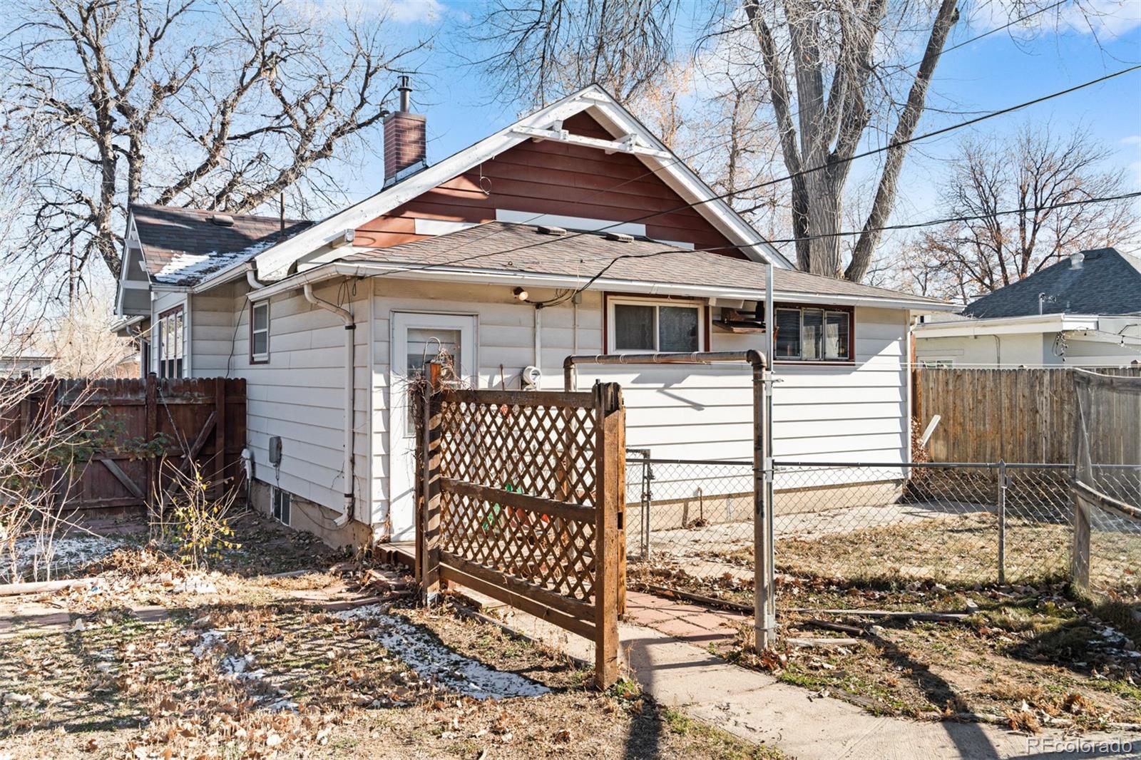 5919 South Bemis Street Littleton, CO 80120 - Photo 37 of 43 a front view of a house with a yard