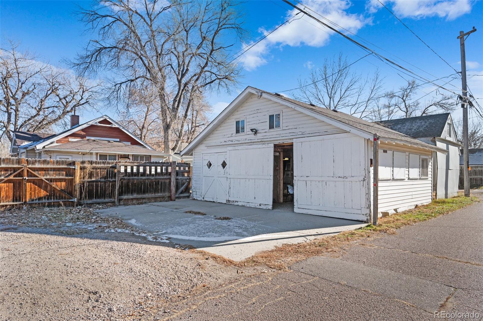 5919 South Bemis Street Littleton, CO 80120 - Photo 42 of 43 a view of a house with a yard and garage