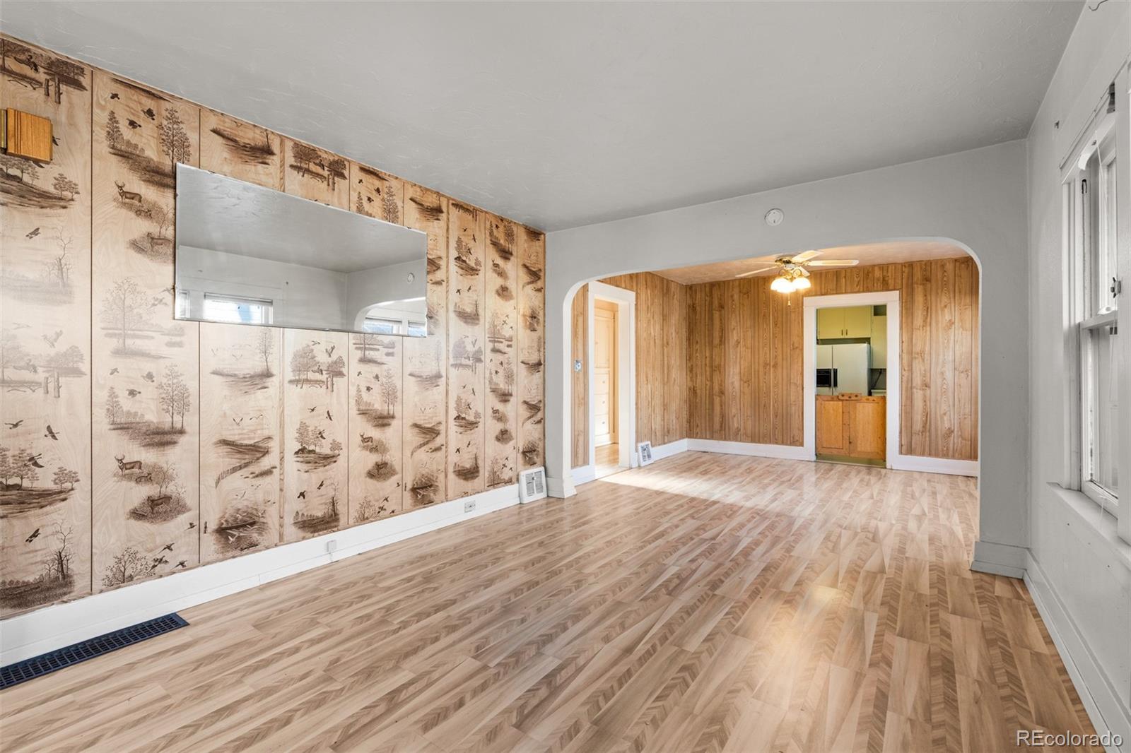 5919 South Bemis Street Littleton, CO 80120 - Photo 6 of 43 a view of a hallway with wooden floor and a bathroom